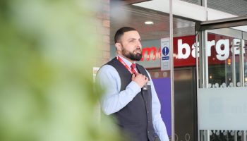 Security officer welcoming shoppers at a retail destination